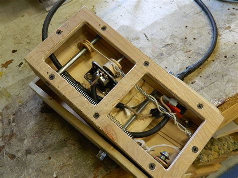 A Wooden Box With Some Tools In It On A Table Next To Scissors And Wires