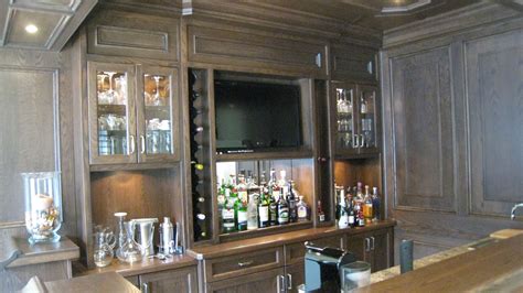 Stylish home bar ideas for your space. Custom wet bar in oak with appliances and TV built in ...