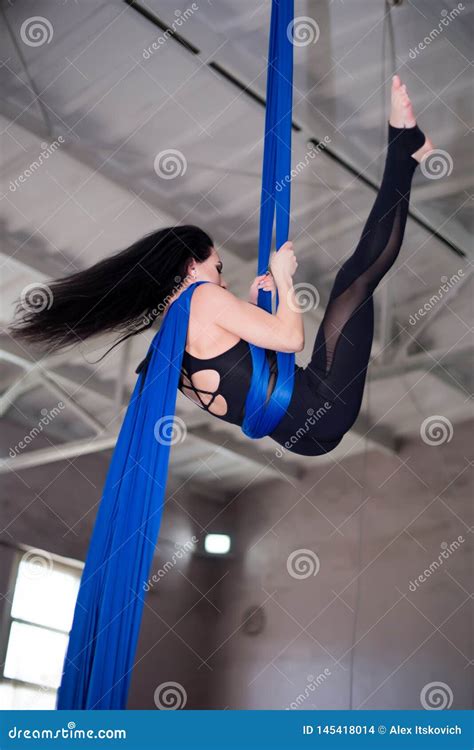Acrobatic Gymnast Is Arching Her Back On The Beach Royalty Free Stock Image