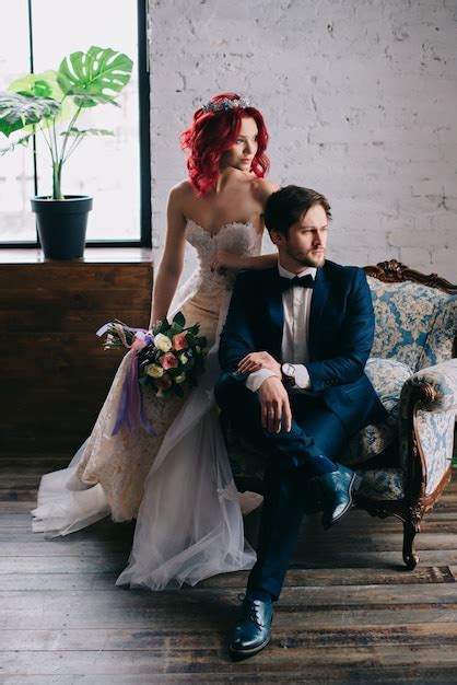 Premium Photo Portrait Of Stylish Newlyweds Sitting In A Vintage Chair