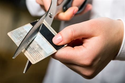 Premium Photo Cutting Up Credit Card With Scissors