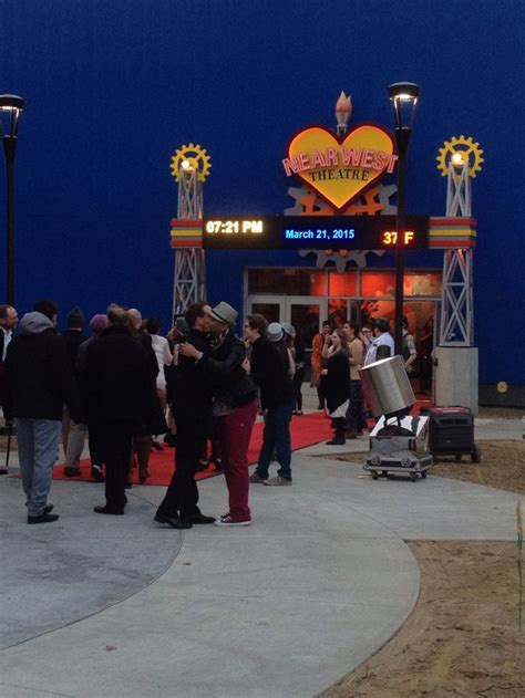 People Are Standing In Front Of The Entrance To An Amusement Park At