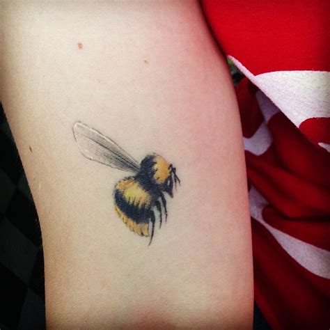 Outstanding heart shaped bumblebee tattoo make on forearm. 45+ Latest Bumblebee Tattoos Collection