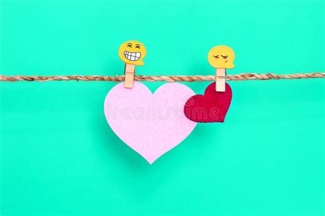Red And Pink Heart Shape Hanging On Rope With Happy Face Icon For Sweet