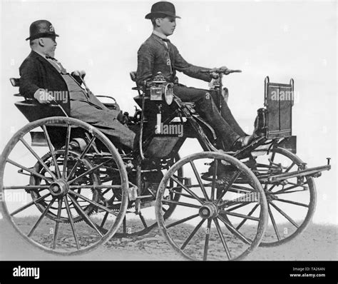 Gottlieb Daimler In Seinem Motor Wagen Am Rad Sein Sohn Adolf Daimler