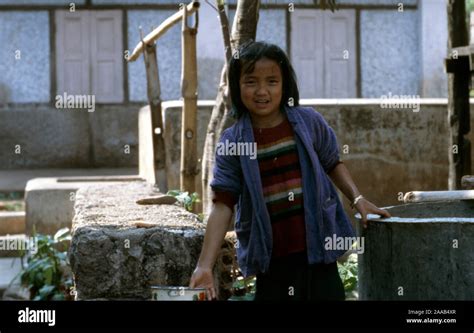 A Young Indigenous Palaung Girl Collects Water From The Well In Her
