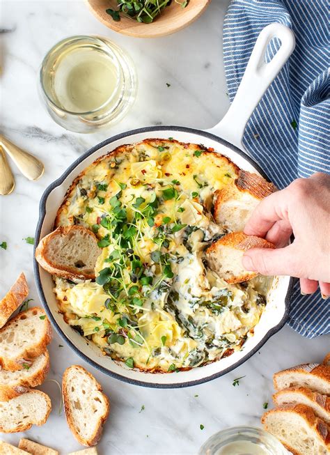This hot spinach artichoke dip is rich, creamy, cheesy, packed with flavor and takes less than 10 minutes to prep! Spinach Artichoke Dip Recipe - Love and Lemons