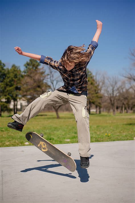 Young Boy Doing A Skateboard Trick By Stocksy Contributor Boris