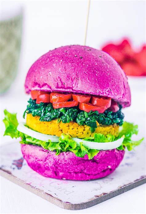 A Purple Burger With Lettuce Tomatoes And Other Toppings On A Plate