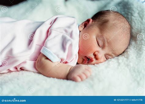 Peaceful Sweet Newborn Infant Baby Lying On Bed While Sleeping In A