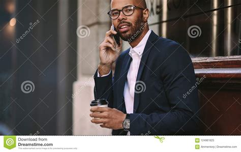 Man In Business Suit Talking Over Cell Phone Outdoors Stock Image