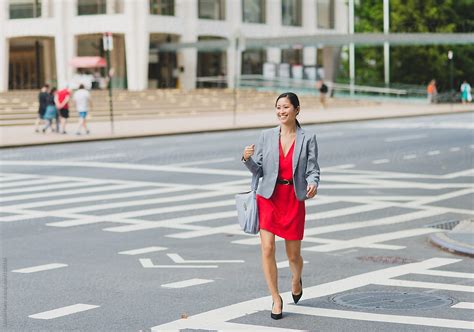 Working Woman Walking Across Street In New York City By Stocksy