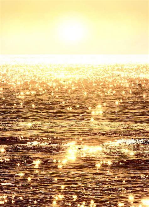 Alluring Sunlight Reflects Upon The Glassy Ocean Waves Casting Dazzling
