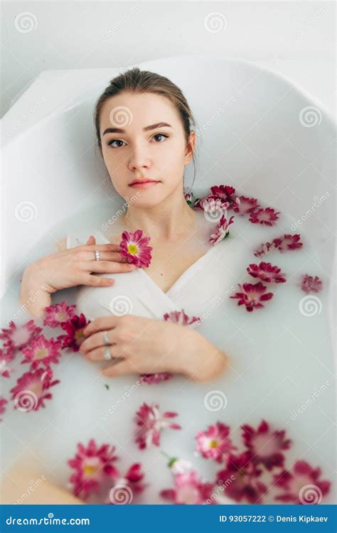Woman Lies In A Bath With Milk Among The Flowers Stock Photo Image Of