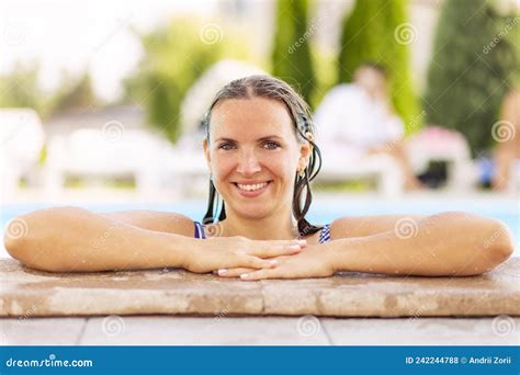 Portrait Of Relaxed Attractive Tanned Woman Lean On Swimming Pool