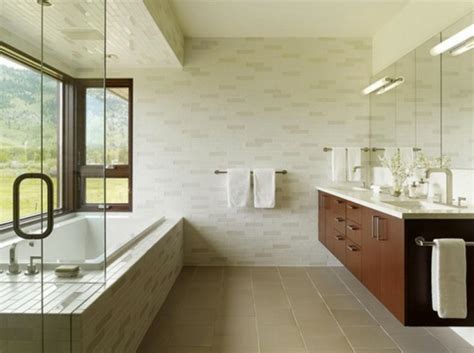 Das elegante badezimmer verfügt über eine freistehende badewanne auf dem marmorboden vor einer glasdusche mit regenduschkopf und grau weißer marmoreinfassung nordwesten usa. Elegantes Badezimmer Interior