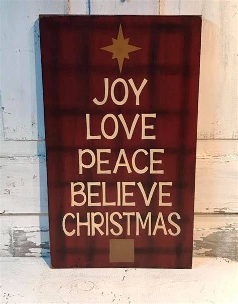 A Wooden Sign That Says Joy Love Peace Believe Christmas