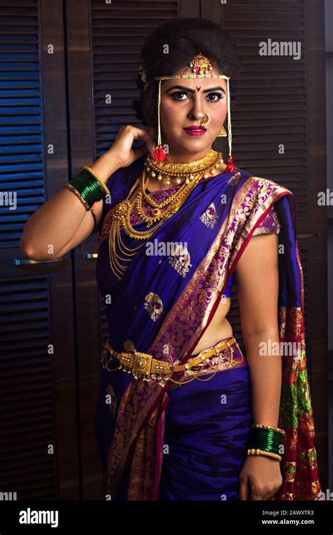 beautiful indian marathi bride in traditional nauvari saree and jewelry looking at camera stock