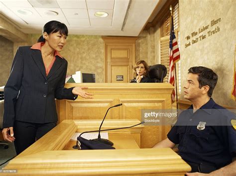 Side Profile Of A Witness And A Lawyer On The Witness Stand With The