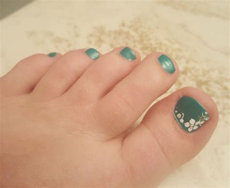 Super Cute Pedicure Idea Turquoise With White Flower And Design On Big
