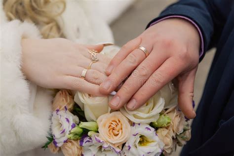 Hands Of Bride And Groom With Rings On Wedding Bouquet Marriage Concept Stock Image Image Of