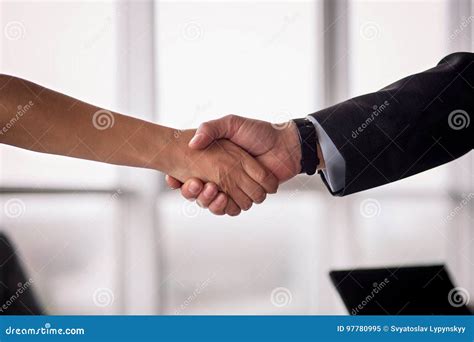Businessman And Businesswoman Shake Hands On Agreement Stock Image