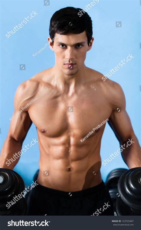 Handsome Muscular Man With Sexy Body Uses His Dumbbell To