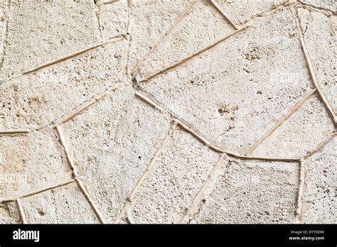 Stone Wall With Decorative Relief Stucco Pattern Background Photo