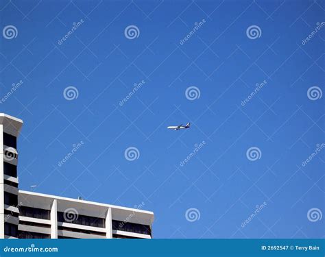 Airplane And Building Stock Image Image Of Overhead Airplane 2692547