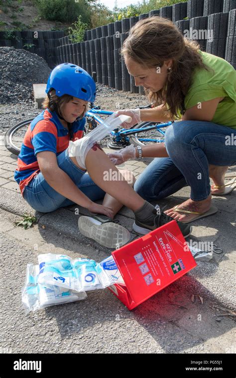 Symbolic Photo First Aid Scene Posed Wound Care After A Bike