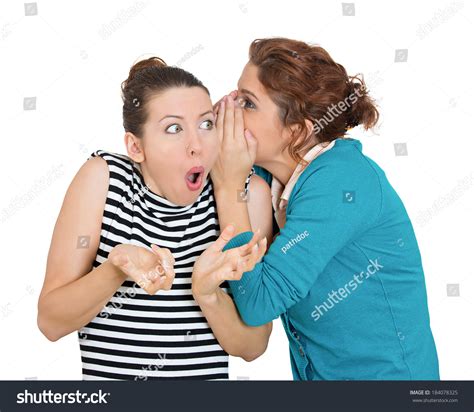 Closeup Portrait Of Girl Whispering Into Woman S Ear Telling Her Something Funny And Shocking