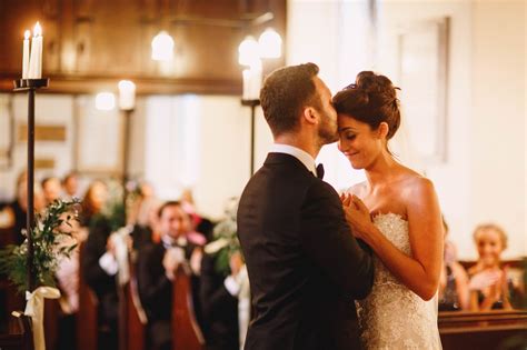 Groom Kisses Bride On The Head During A Church Wedding Ceremony In