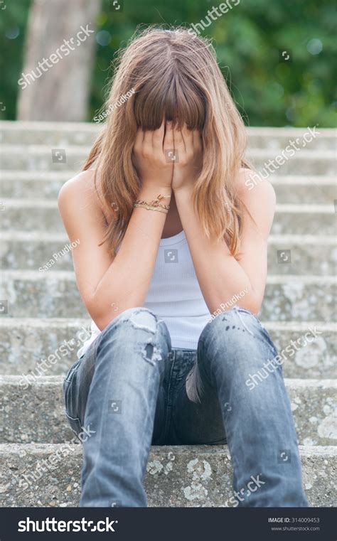 Sad Teenage Girl Sitting Alone On Stock Photo Edit Now
