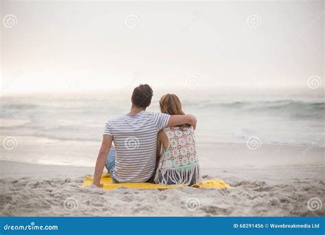 Rear View Of Couple Sitting On The Beach Stock Photo Image Of