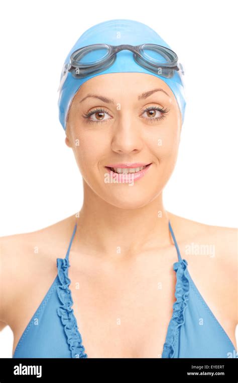 Vertical Shot Of A Female Swimmer With Black Swimming Goggles And Blue Swim Cap Isolated On