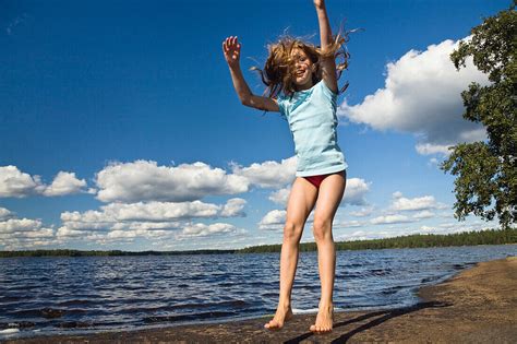 Nine Year Old Girl Jumping In The Air At License Image