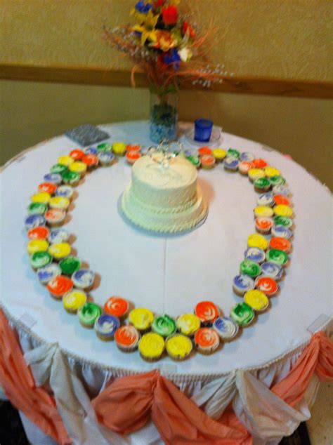 Colored Cupcakes Around White Wedding Cake White Wedding