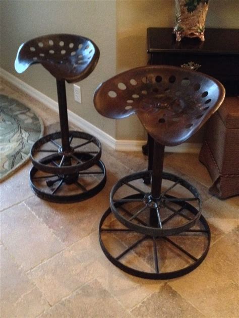 Tractor seat bar stools are unique and antique chair; Counter stools from old tractor seats and wagon wheel ...