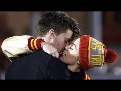 Miley Cyrus And Patrick Schwarzenegger Spotted Kissing Smooching At A USC Football Game YouTube