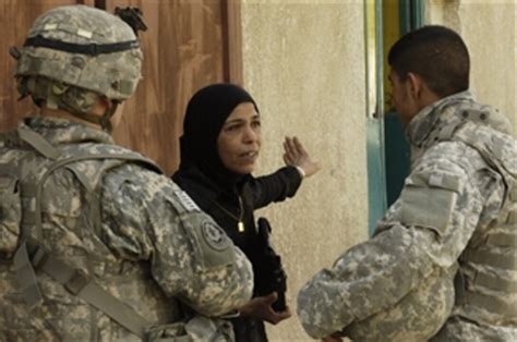 A Us Army Soldier And An Iraqi Interpreter Talk To An Iraqi Woman