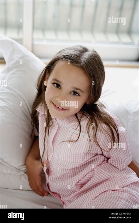 Portrait Of A Young Girl Laying On A Bed Stock Photo Alamy
