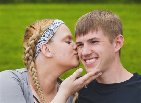 Young Loving Girl Kissing Her Boyfriend On Cheek Stock Image Image Of