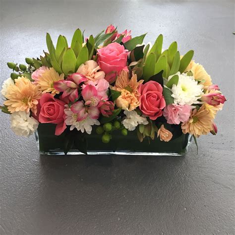 Long And Low Set Flower Table Arrangement In Bright Colour Tones Created By Madison In Bloom