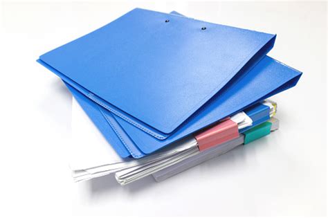 Blue Files Folder And Paper On White Table In Office Stock Photo