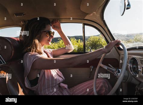 Woman driving a vintage car Stock Photo - Alamy
