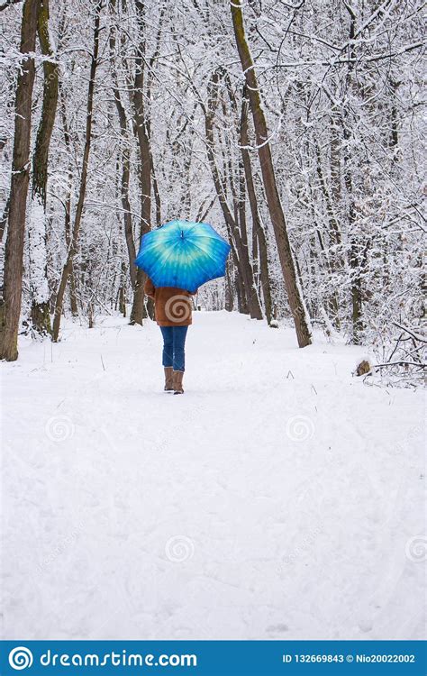 Girl Under Blue Umbrella In Snowy Forest Snowfall Concept Woman Under