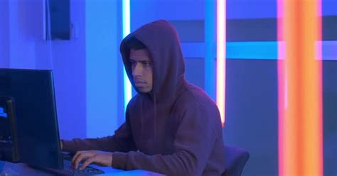 African Hacker Dressed In Hoodie Working On The Computer Stock Video