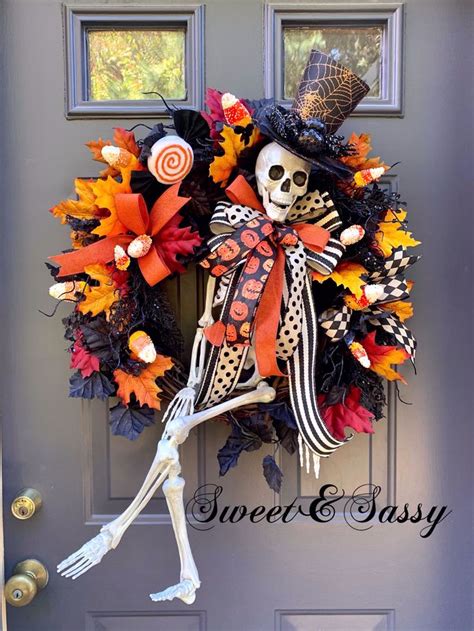A Halloween Wreath With A Skeleton Wearing A Top Hat