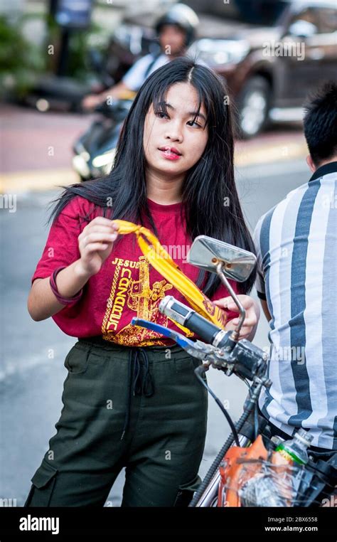 A Beautiful Filipino Girl Checks Her Hair Before Heading Out On The Famous Annual Black Nazarene
