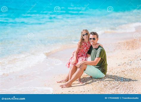 Happy Father And His Adorable Little Daughter At Tropical Beach Having